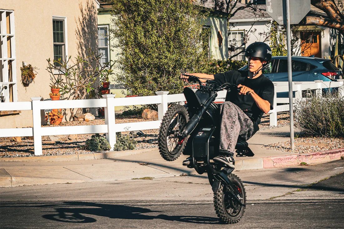 Gyroor GT54Pro electric dirt bike jumping over a dirt mound
