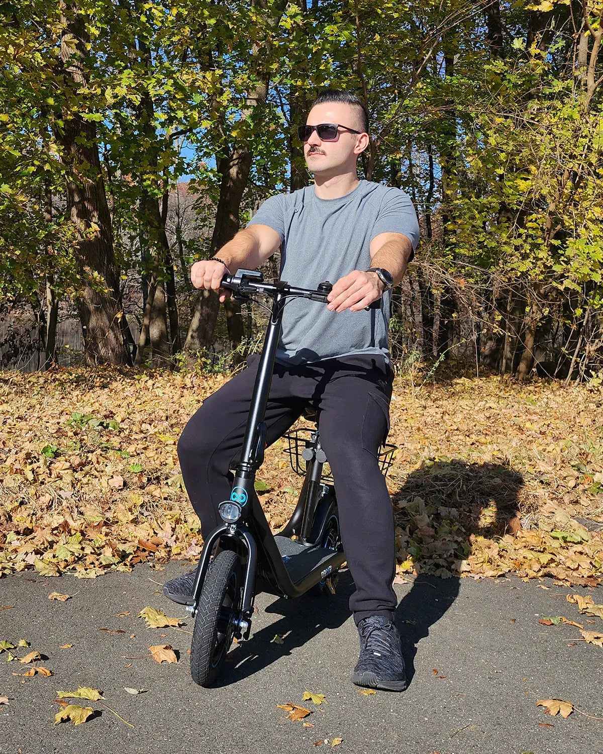 man riding seated electric scooter in a residential yard