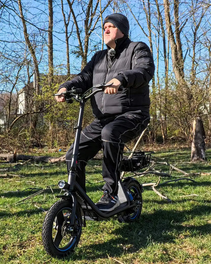Adult enjoying a ride on the Gyroor C1Plus electric scooter in a park