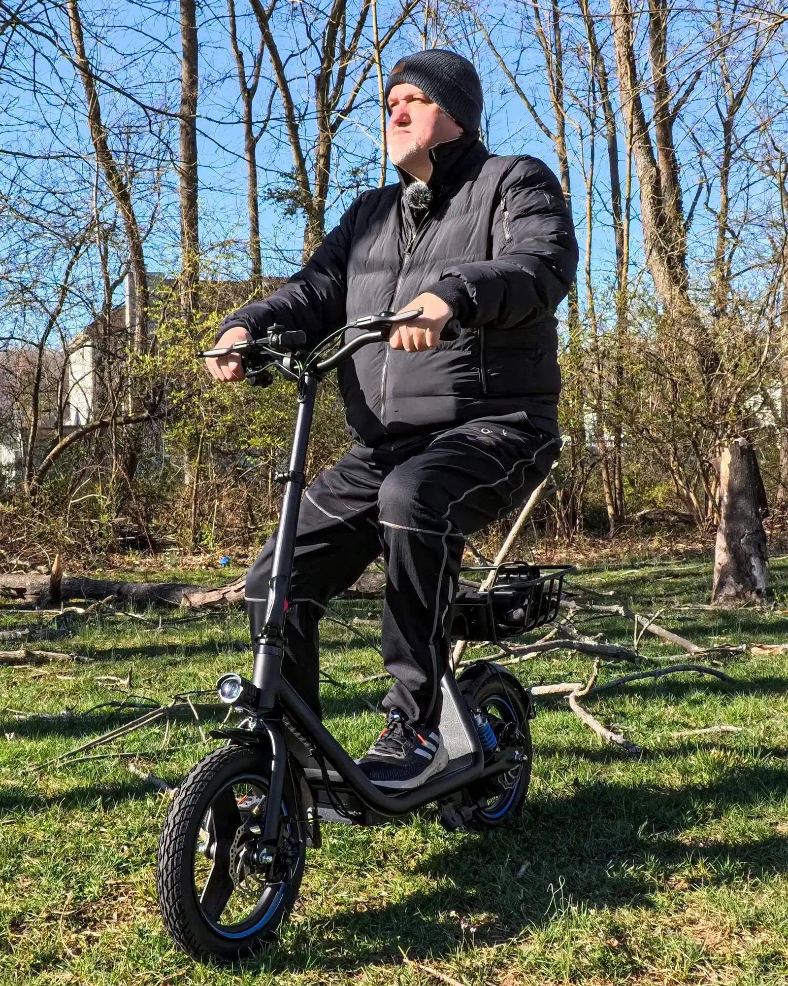 Adult enjoying a ride on the Gyroor C1Plus electric scooter in a park