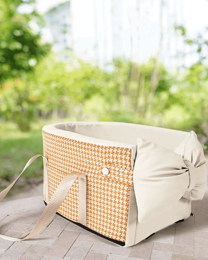 Orange and white houndstooth padded pet basket insert with beige straps and button, designed for outdoor use on patio or garden