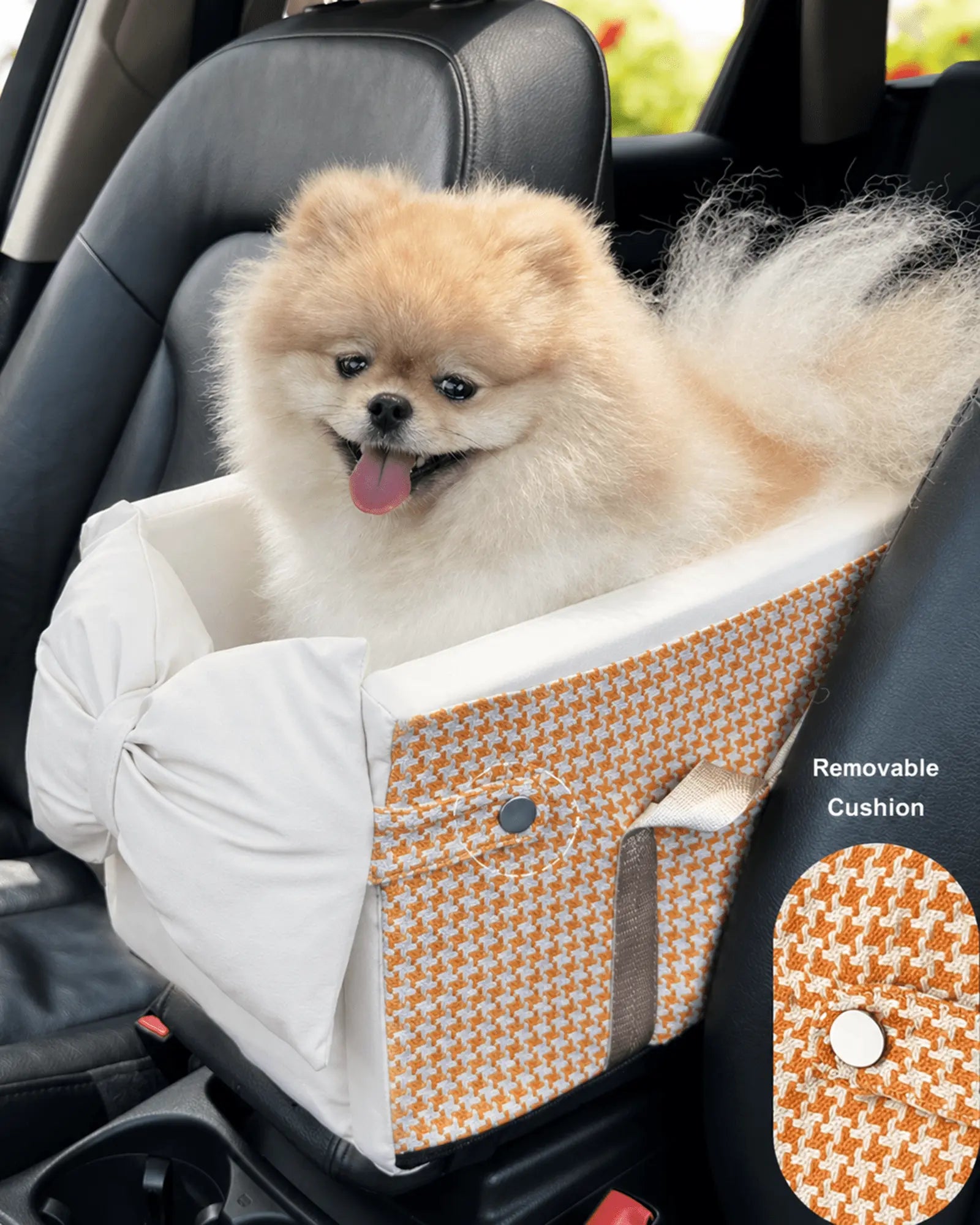 Small fluffy Pomeranian dog sitting in a removable cushion with orange and white houndstooth pattern in electric scooter backseat