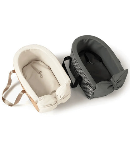 Cream-colored pet carrier with padded interior and beige straps, designed for comfort and security during travel