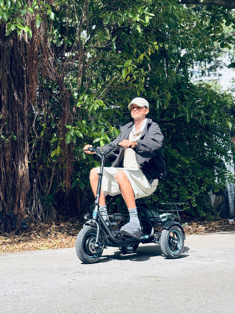 Gyroor C5 electric trike riding through a park with a comfortable seated design and stable three-wheel performance