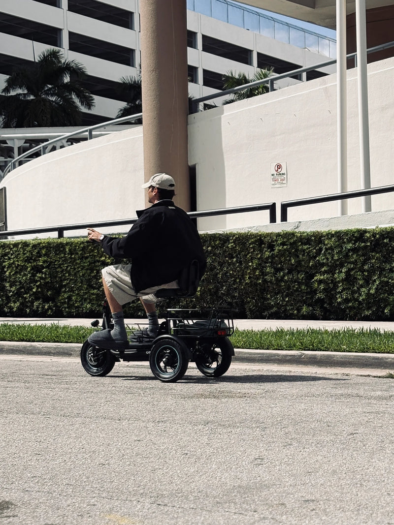 Rear view of the Gyroor C5 electric trike during a smooth outdoor ride with rear cargo basket