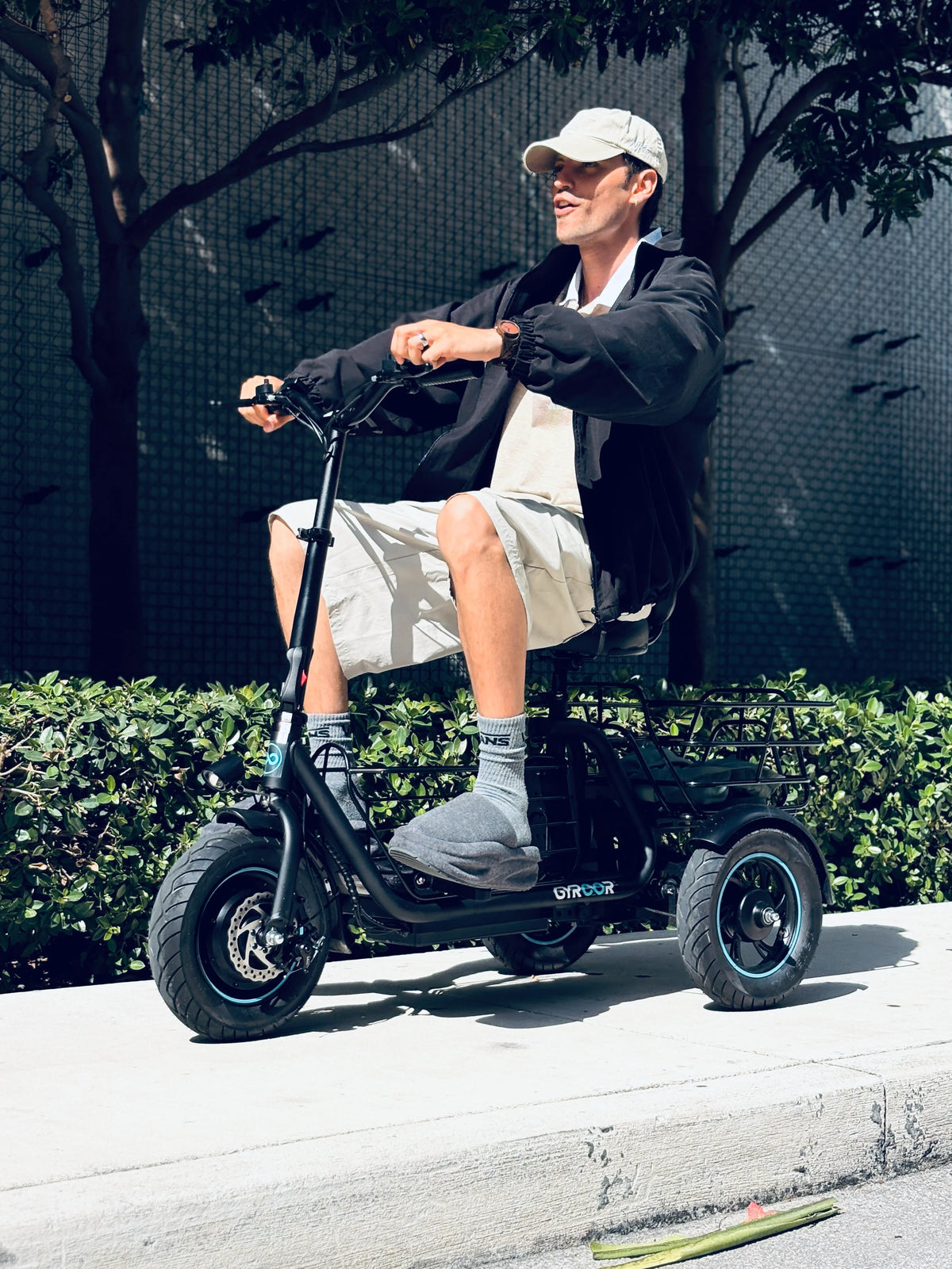 Adult riding the Gyroor C5 electric trike with dual baskets for everyday urban commuting