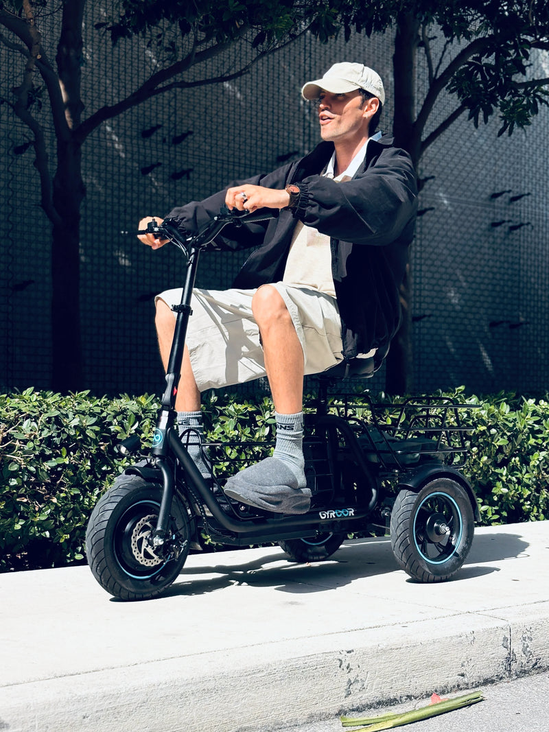 Adult riding the Gyroor C5 electric trike with dual baskets for everyday urban commuting